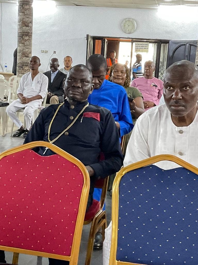 Church leaders and congregation members seated at a community gathering