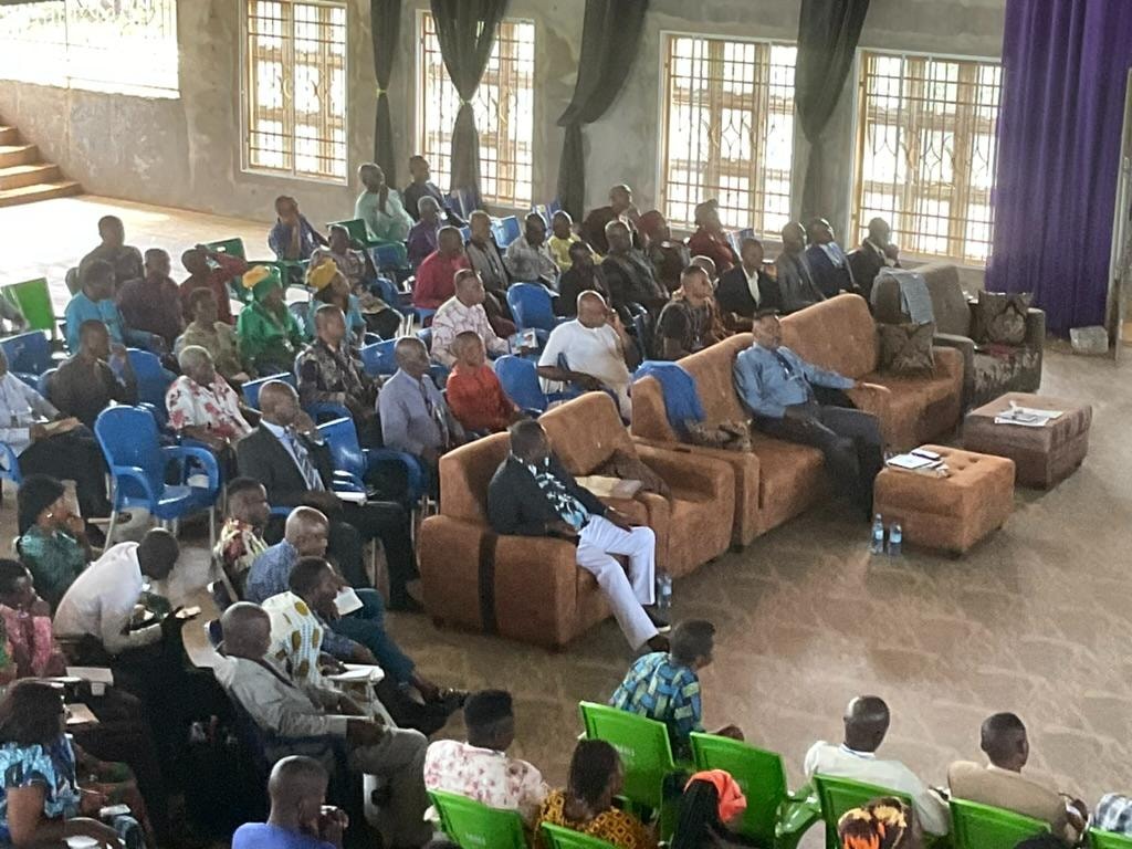 Large congregation gathered in a community hall for a church service