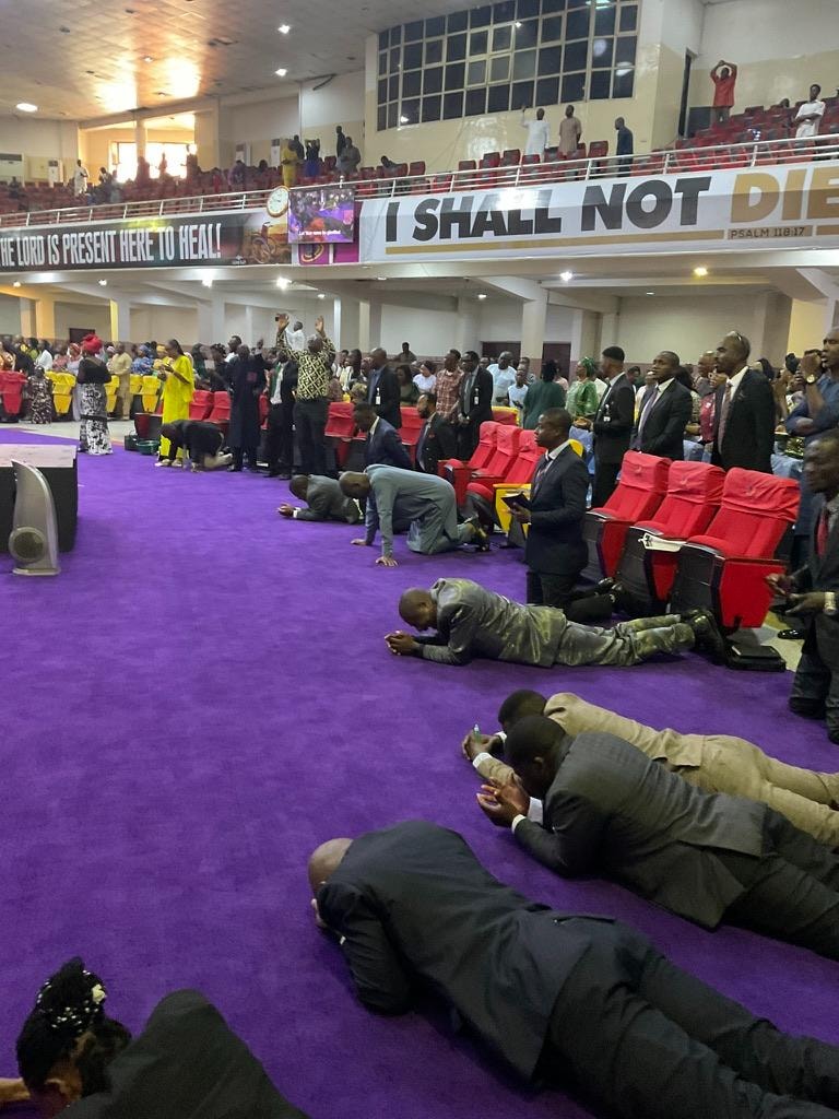Ministers and congregation in deep prayer and worship